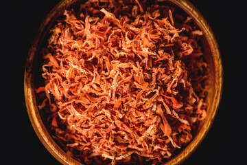 Dried carrots in wooden plate for cooking. Vegetable drying in dehydrator. Healthy and healthy food.