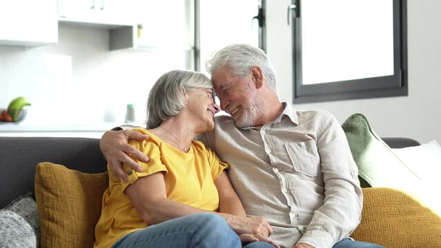 Happy mature couple in love embracing, laughing grey haired husband and wife with closed eyes, horizontal banner, middle aged smiling family enjoying tender moment, happy marriage, sincere feelings
