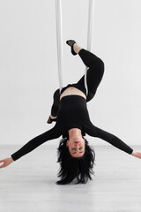 Girl performing aerial dance. training on aerial silks.