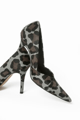 Leopard print calf hair pumps isolated on white. Classic animal print heels with sharply pointed toes.