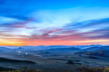 Beautiful mountain and colorful sky clouds landscape at sunrise in Inner Mongolia, China.
