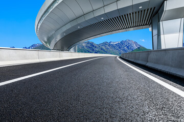 Asphalt road and bridge with mountain background