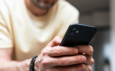 Male person using his cellphone closeup photography.
