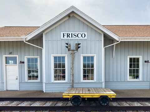 Frisco, Texas, USA - April 10, 2023. Frisco train station entrance, museum exhibition, trolley on platform, retro transportation