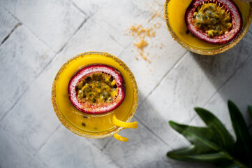 Mango and Passion fruit smoothie on a grey background. Exotic tropical vitamin drink from fresh ingredients. Healthy food concept.