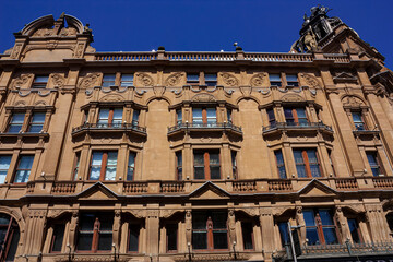 Fototapeta na wymiar Stone facade of an old urban building