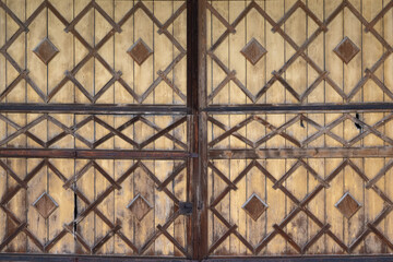 Historical barn door with wooden decoration