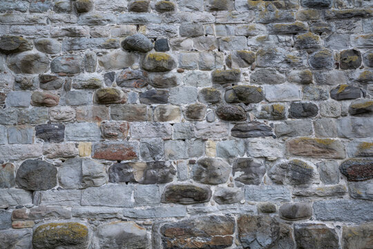 Medieval stone wall, castle wall of natural stone