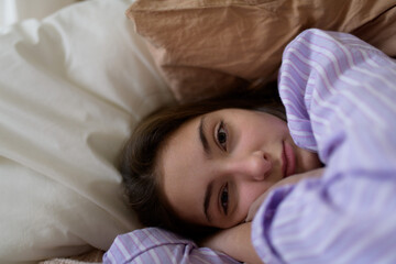Close-up of teenage girl lying in her bed.