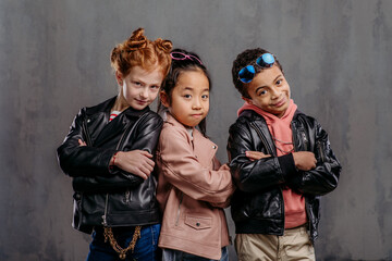 Portrait of three children with leather jacket.