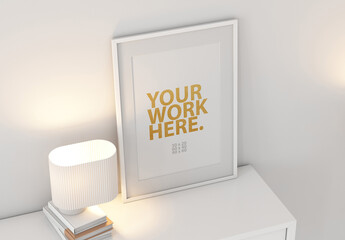 White Poster Art Frame Mockup with passepartout on commode with lamp