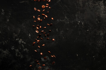 Roasted coffee beans falling on black background, Concept for coffee product advertising, Selective focus, place for text