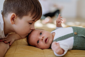 Portrait of boy kissing his younger brother.