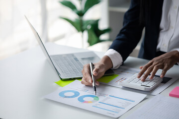 A female financier is reviewing company financial documents, monthly financial statement summary...