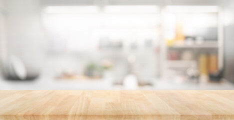 Selective focus.Wood table top on blur kitchen counter background.For montage product display or...