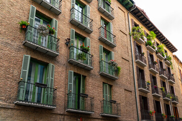 Pamplona, Navarra, SPAIN. The beautiful streets of the city of Pamplona. Beautifully coloured buildings with flowers of different colours, hanging from the balconies. Empty street, no peoples