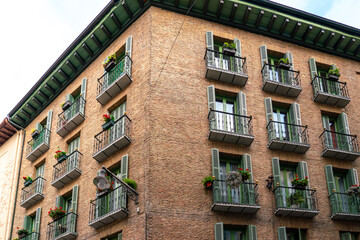 Pamplona, Navarra, SPAIN. The beautiful streets of the city of Pamplona. Beautifully coloured buildings with flowers of different colours, hanging from the balconies. Empty street, no peoples