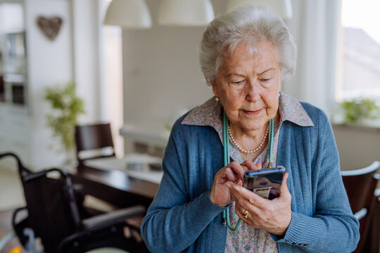 Portrait of senior woman with the smartphone.