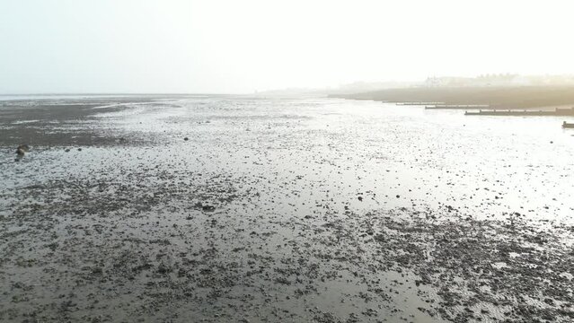 Low shot of low tide beach sunrise, Whitstable, UK
