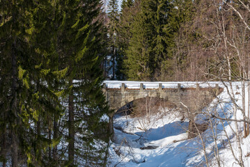 Old stone bridge in winter weather.