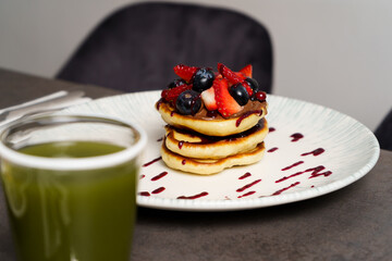 American pancake with strawberries, Blueberries and Syrup