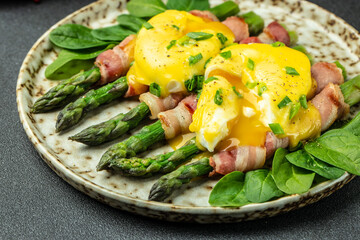 asparagus with bacon, poached egg and hollandaise sause. Food recipe background. Close up.