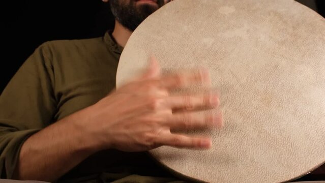 man playing tamburine