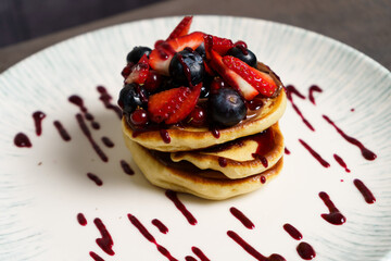 Close Up of American pancake with strawberries, Blueberries and Syrup
