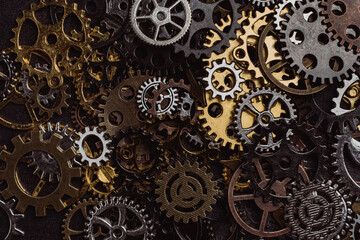 Shiny gears of cold steel colors on dark background