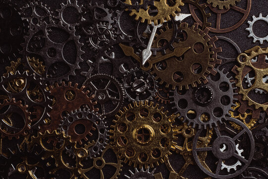 Shiny gears of cold steel colors on dark background
