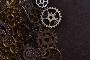 Shiny gears of cold steel colors on dark background
