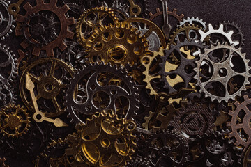 Shiny gears of cold steel colors on dark background