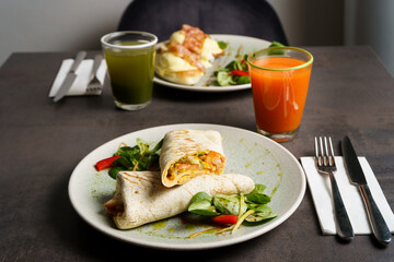 Wrapped Burrito with Beans and Vegetables on a Plate, two meals on the table