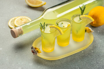 italian lemon liqueur limoncello in small glasses and bottle. Italian alcoholic drink. place for...