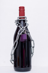Chain with a lock on a bottle of wine.