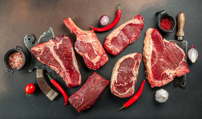 Variety of Raw Black Angus Prime meat steaks T-bone, tomahawk, New York steak. Set raw marbled beef...