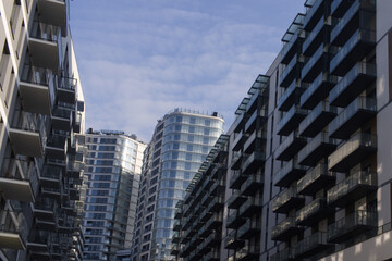 Obraz premium Facades of large residential buildings against the blue sky.