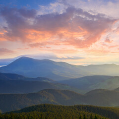 mountain chain silhouette in blue mist at the dramatic twilight