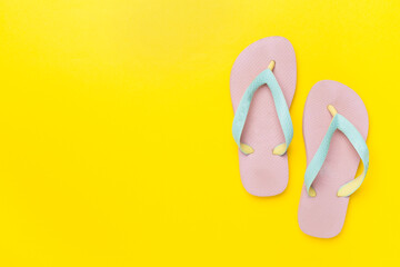 Bright flip flops on color background, top view