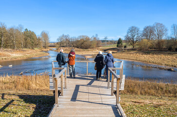 Tourists admiring the confluence of the rivers Brigach and Breg, which forms the beginning and...