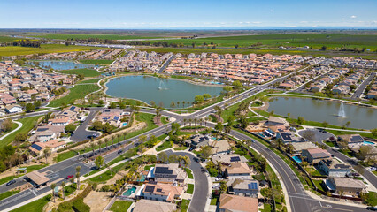 Drone photos over The Lakes community in Discovery Bay, California with houses, houses with solar,...
