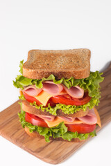 Club sandwich with ham, cheese, tomato and lettuce. 