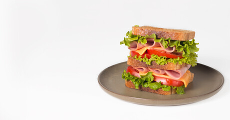 Club sandwich with ham, cheese, tomato and lettuce. 