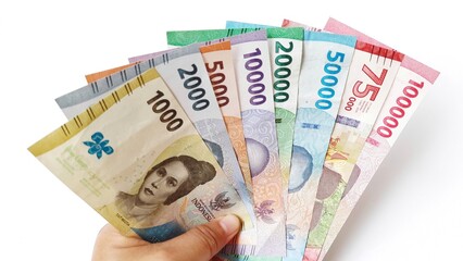Hand holding showing indonesia rupiah, new rupiah money series banknotes for buying, selling, isolated on white background