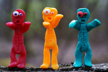 Figures of three funny different zombies. Colorful toys.