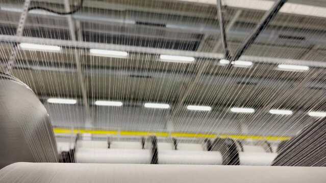 The unwinding of the threads from the bobbin of the warp of the knitting machine