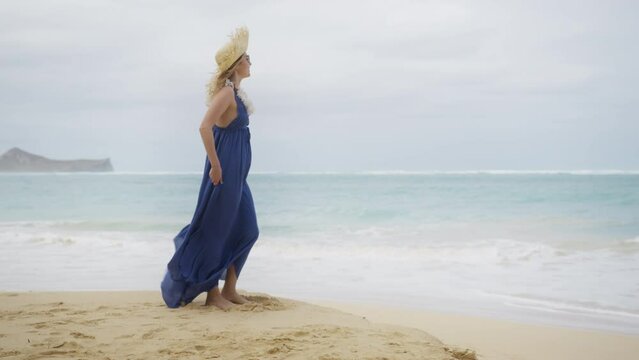 30s authentic traveler woman in purple maxi boho style dress enjoying view of Hawaiian beach. RED camera panorama shot around travel lady with lei flower neckless standing in scenic nature of Oahu 4K