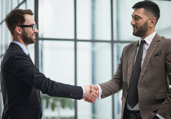 director of the company, glad to meet his new colleague. Handshake and new employee concept.