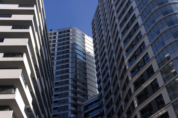 Facades of large residential buildings against the blue sky.