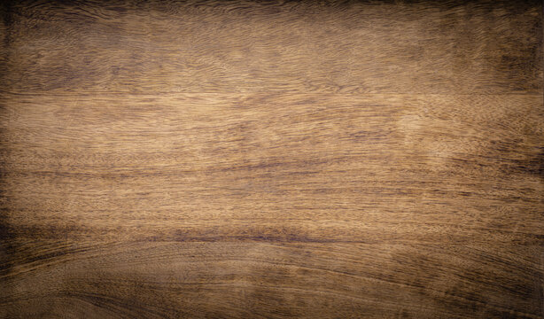 Dark brown rough grainy mango wood texture background